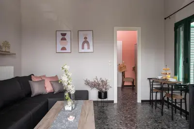 a living room with a black couch and a table at Square Apartment in Kambanós