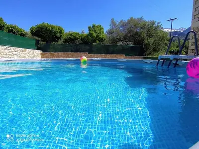 a swimming pool with a ball in the water at Traditional Villa in Pemonia in Pemónia