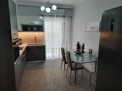 a kitchen with a table and chairs in a room at SummerSense Apartment in Chania Town