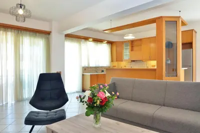 a living room with a couch and a table with flowers at Gavalas Urban Home in Chania Town