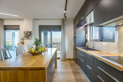 a kitchen with a bowl of fruit on a wooden counter at Casa Galatas in Galatás