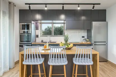 a kitchen with two bar stools and a counter top at Casa Galatas in Galatás