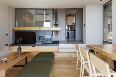 a living room with a dining table and a television at Omma Villas in Chania Town