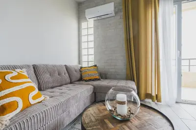 a living room with a couch and a table at D&G Lux Flat City View next to Old Town & Market in Chania Town