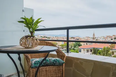 a table with a plant on a balcony with a view at D&G Lux Flat City View next to Old Town & Market in Chania Town