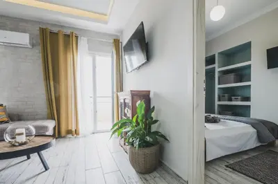 a living room with a bed and a table at D&G Lux Flat City View next to Old Town & Market in Chania Town