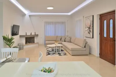a living room with a couch and a table at Ianthe Apartment in Kissamos