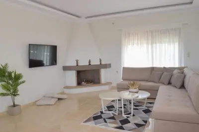 a living room with a couch and a fireplace at Ianthe Apartment in Kissamos