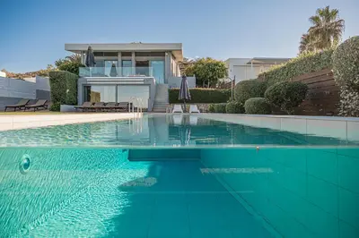 a swimming pool in front of a house at VILLA NIBA in Kalathas