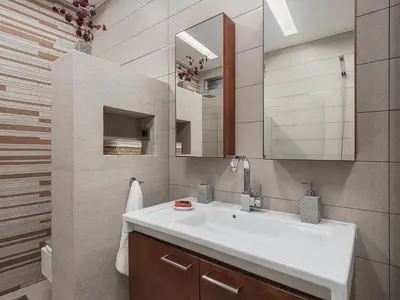 a bathroom with a white sink and a mirror at VILLA NIBA in Kalathas