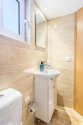 a bathroom with a white toilet and a sink at Neva's Apartment's in Center Chania 1 2 in Chania Town