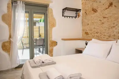 a bedroom with a bed with towels on it at Casa Piedra in Nohia