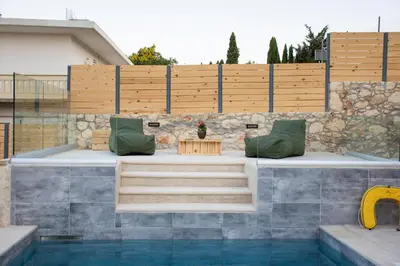 a patio with a table and chairs next to a pool at Casa Piedra in Nohia