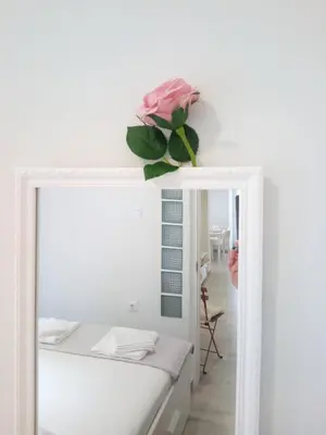 a pink rose sitting on top of a mirror at Sea U in Chania Town