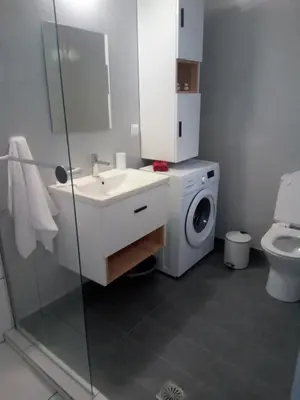 a bathroom with a sink and a washing machine at Sea U in Chania Town