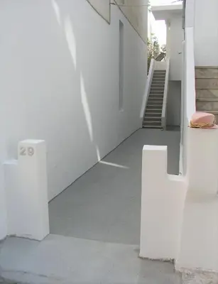 a stairway with white walls and white stairs at Sea U in Chania Town