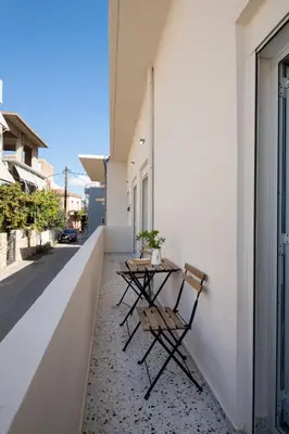 two chairs and a table on the side of a building at Michalis NCHouse 33 in Chania Town