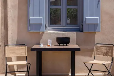 a table with two chairs and a blue cabinet at AZADE Chania in Chania Town