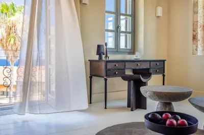 a desk in a room with a window and a bowl of fruit at AZADE Chania in Chania Town