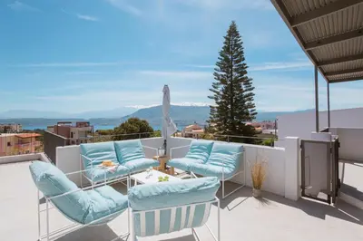 a patio with chairs and a table and a tree at Hermes&Dione in Argoulidhés