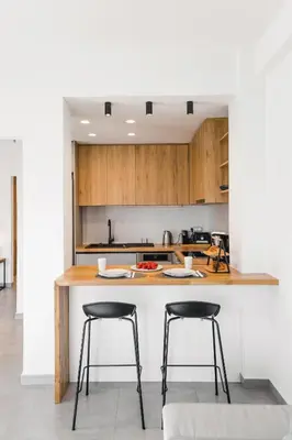 a kitchen with two bar stools at a counter at Hermes&Dione in Argoulidhés