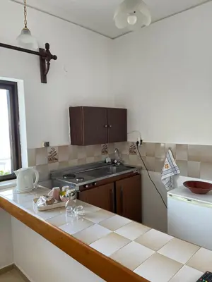 a kitchen with a sink and a counter top at Aeolos Apartments Kolymbari in Kolymvari