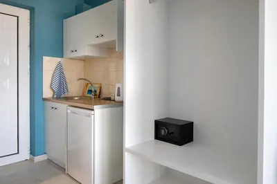 a small kitchen with a sink and a refrigerator at Evi Boutique Rooms in Galatás