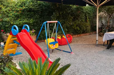 a playground with two swings and a slide at ''Meraviglia casa'' Irida apartment in Chania Town