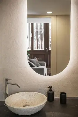 a bathroom with a sink and a mirror at Copal Experience The Port in Chania Town