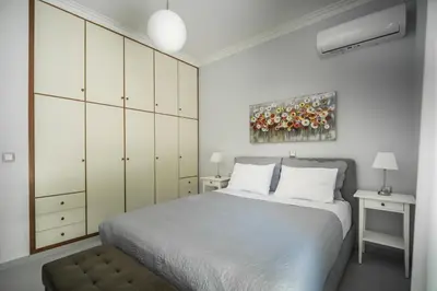 a bedroom with a bed and a painting on the wall at The Nest of Urban Living by 8essentially in Chania Town