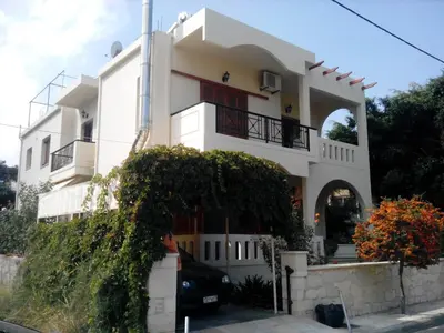 a white house with an archway in front of it at Mel Studio 1 (kalamaki) in Kalamaki Chanion