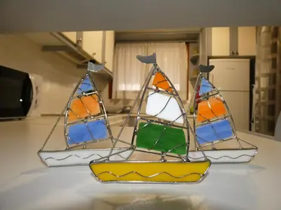 two stained glass sails on top of a table at Mel Studio 1 (kalamaki) in Kalamaki Chanion
