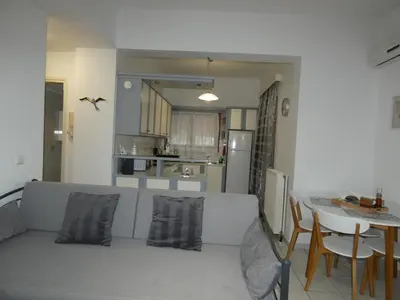 a living room with a couch and a table and a kitchen at Mel Studio 1 (kalamaki) in Kalamaki Chanion