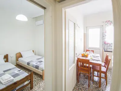 a small room with a table and a bed and a bedroom at Fully renovated apartment close to the bus station and the city center! in Chania Town