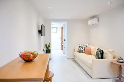 a living room with a white couch and a table at Nem Home, amazing 1 bedroom house in Chania Town