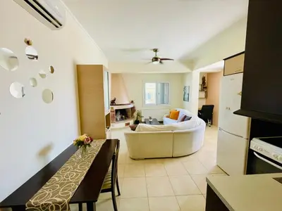 a living room with a couch and a table at Mersini Apartment in Chania Town