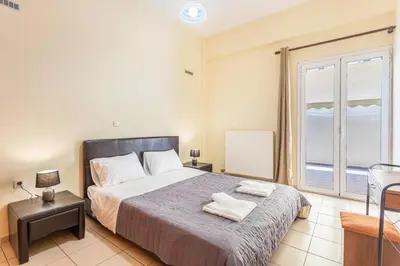 a bedroom with a bed and a window with a view at Neva's House in Chania in Chania Town