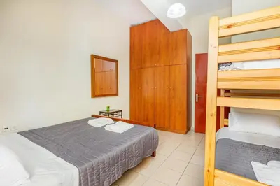 a bedroom with a bed and a bunk bed at Neva's House in Chania in Chania Town