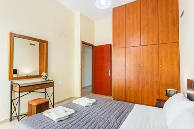 a bedroom with a bed and a dresser and a mirror at Neva's House in Chania in Chania Town