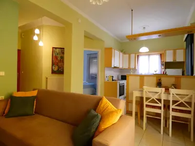 a living room and kitchen with a couch and a table at Mel Studio 2 (kalamaki) in Kalamaki Chanion