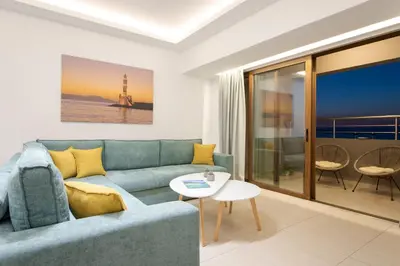 a living room with a blue couch and a table at Overview Chania with sea view and amazing sunset in Chania Town