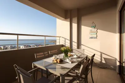 a table on a balcony with a view of the ocean at Overview Chania with sea view and amazing sunset in Chania Town
