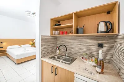 a kitchen with a sink and a bed in a room at SMAROULA in Elafonisi