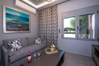 a living room with a couch and a table at Rena's luxury apartment with free private parking in Chania Town