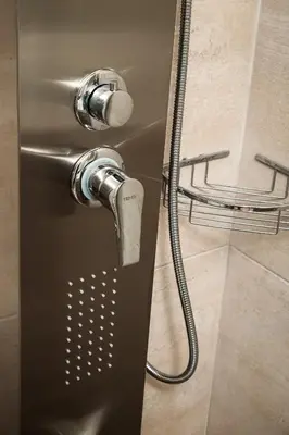 a shower with a faucet in a bathroom at ModernPastel Apartment - Private Parking,Near the Old Port in Chania Town