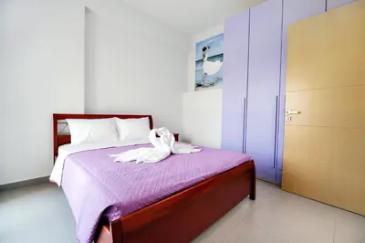 a bedroom with a bed with a stuffed animal on it at Fotini 's apartment near the city center. in Chania Town