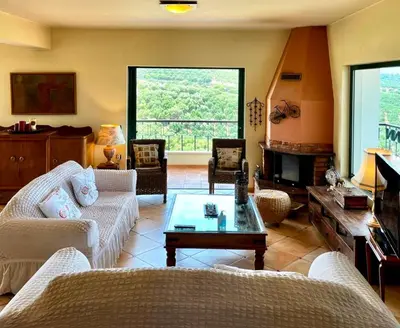 a living room with two couches and a table at Olive Villa Plataniás in Xirokámbion