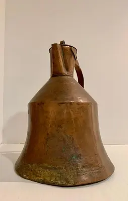 an old bell sitting on top of a table at Aggelos and Thisbe Chania City Apartment in Chania Town