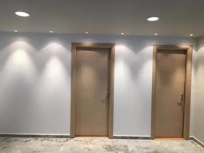 two elevators in a building with their shadows on the wall at Aggelos and Thisbe Chania City Apartment in Chania Town