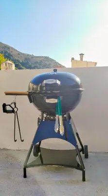 a blue grill sitting on top of a chair at Feneri 3 -Cozy rustic Apt 20' from Elafonisi beach in Elafonisi
